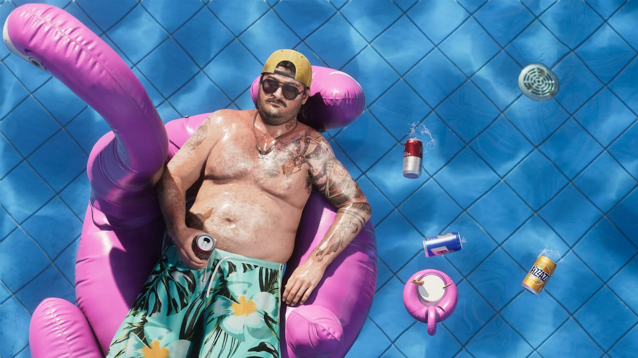 Cal Hampton floats alone in a bright pink backyard pool