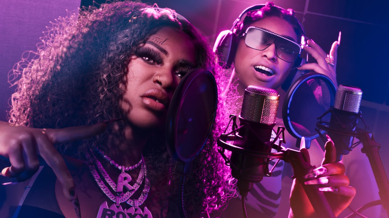 Bae-Luxe and Roxy of Real Dimez record together at a microphone