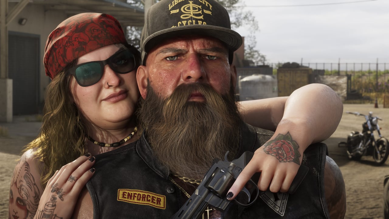 A biker couple poses beside motorcycles in rural Ambrosia