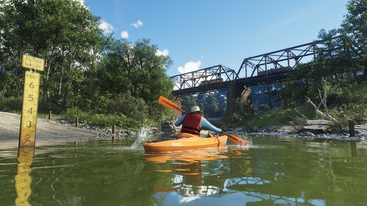 A woman paddles a kayak beneath a bridge in Mount Kalaga National Park